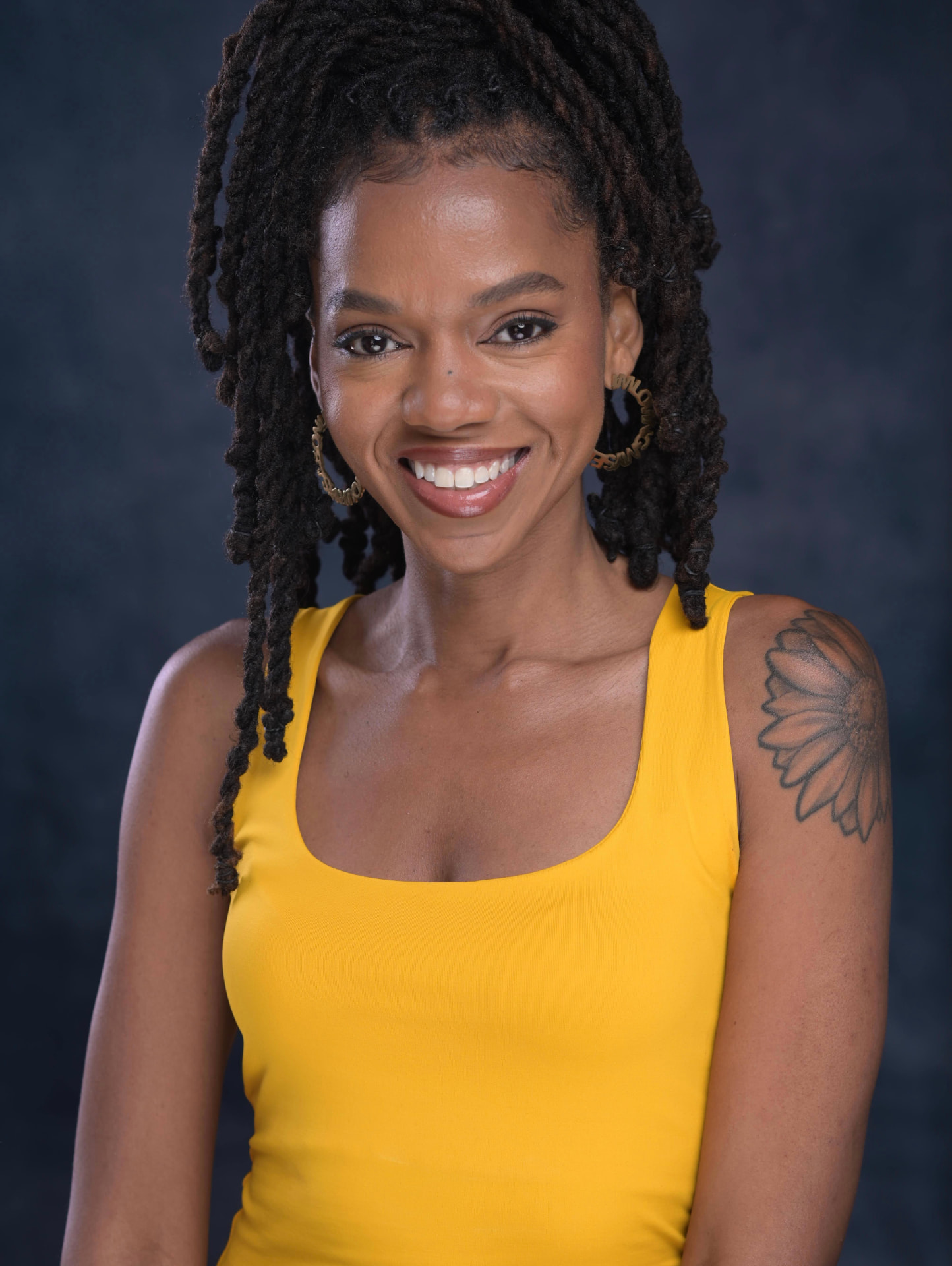 Portrait of Dynasty smiling in a yellow top