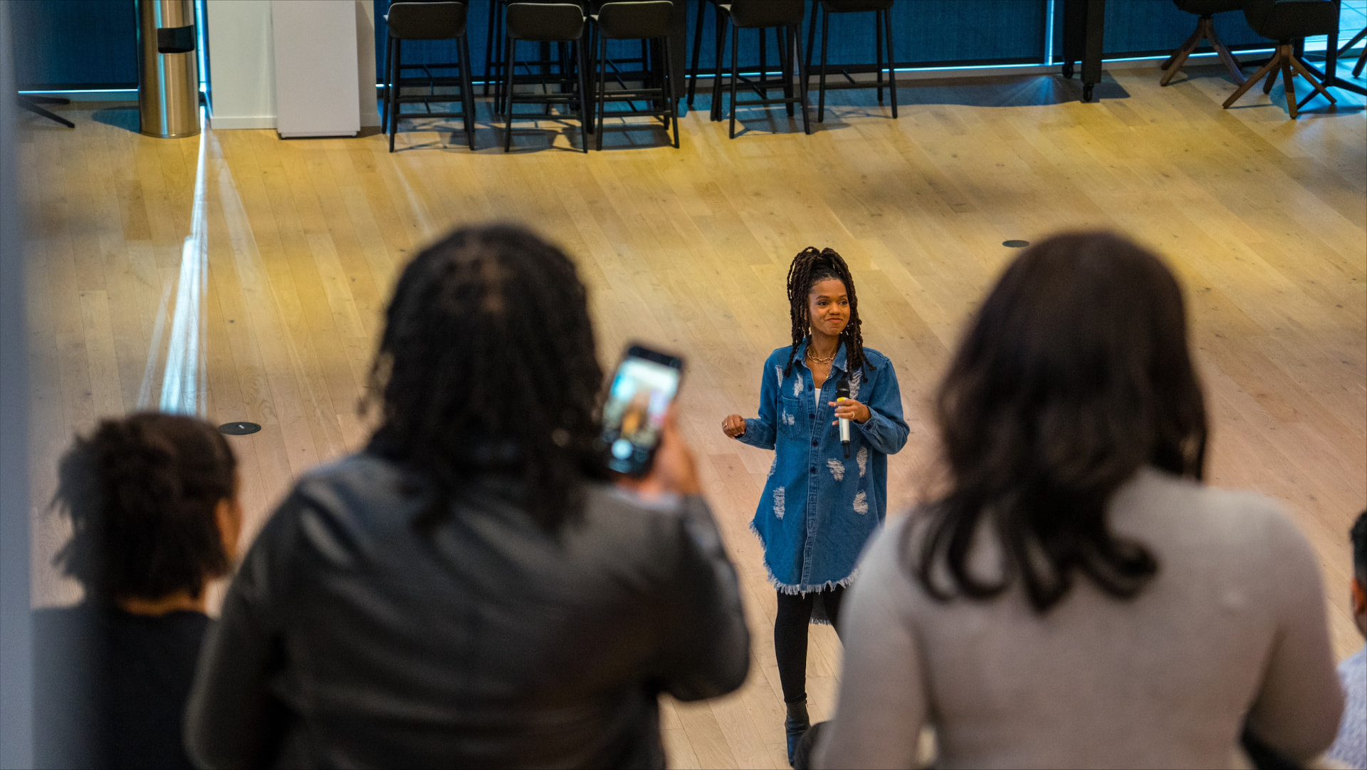 Dynasty leading an interactive experience with an audience gathered around her